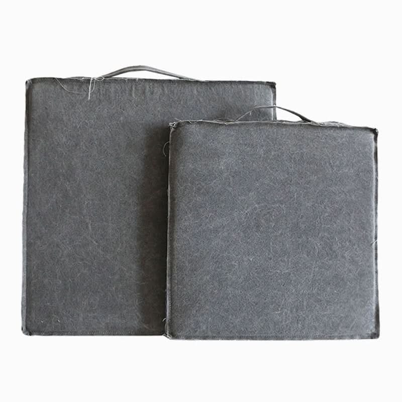 Two grey linen cushions, customizable and distressed, with removable covers.