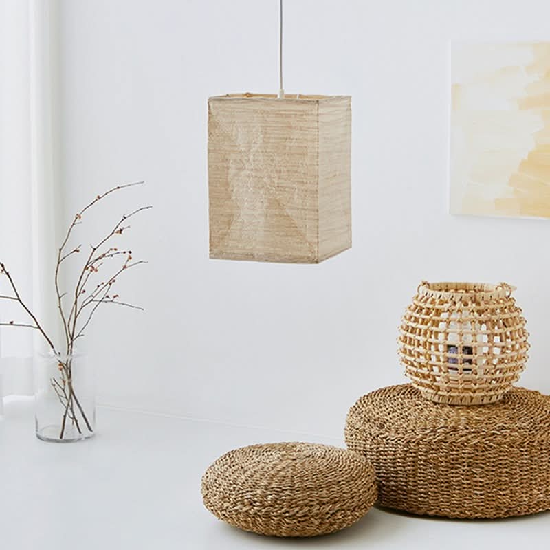 Natural fiber squared paper lampshade hanging in a bright room with decorative baskets.