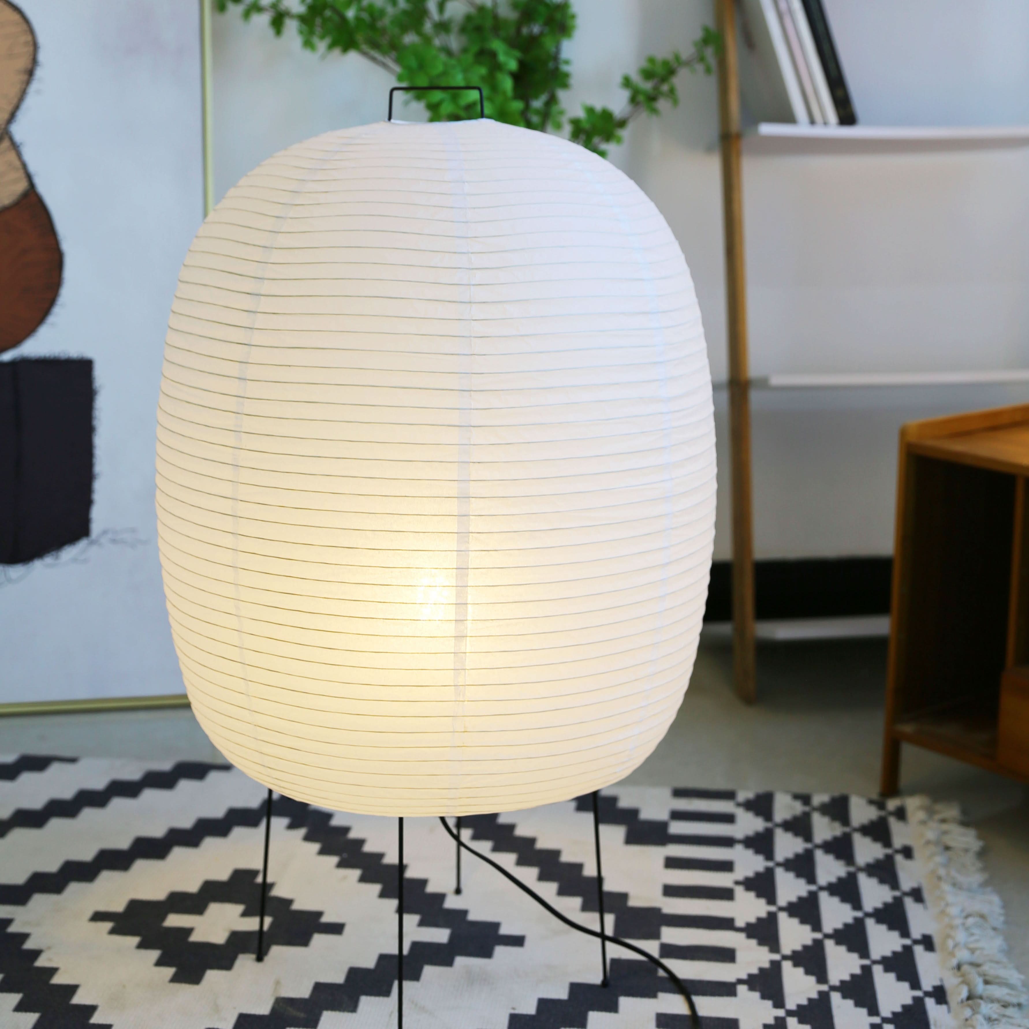 Spherical Floor Paper Lamp (50x80cm) illuminates a modern living room with a black & white rug.