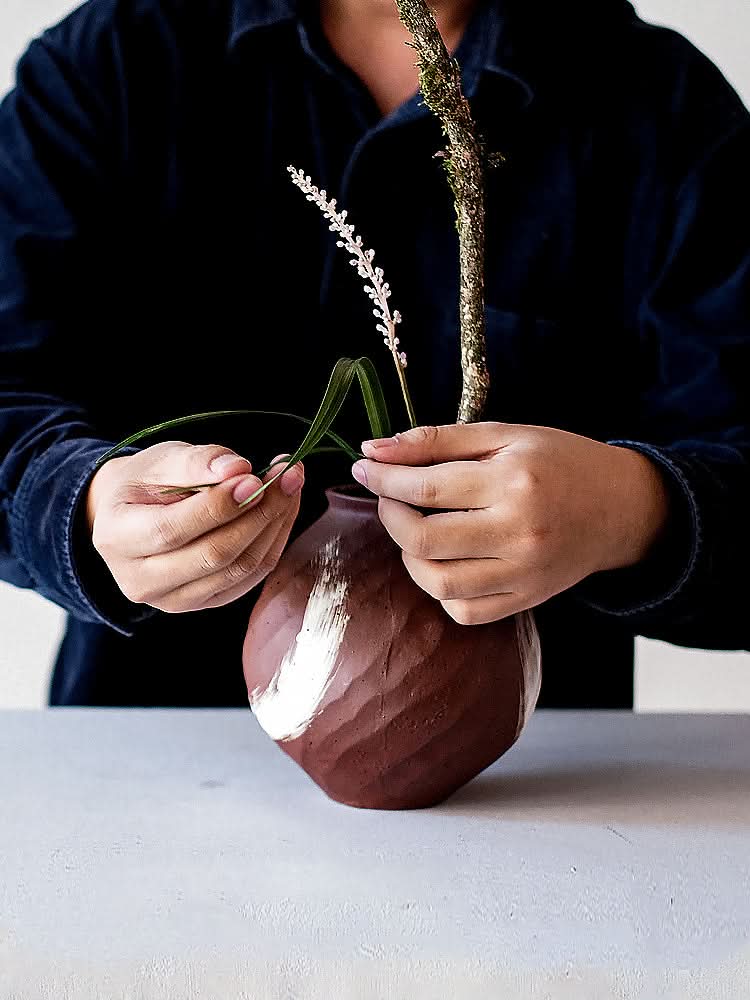 Brown vase with a brushed stroke, textured ceramic home decor accessory.