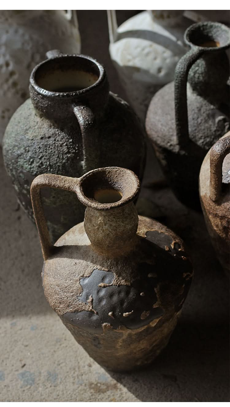 Wabi-sabi small ceramic vase with textured, rustic finish in earthy tones.