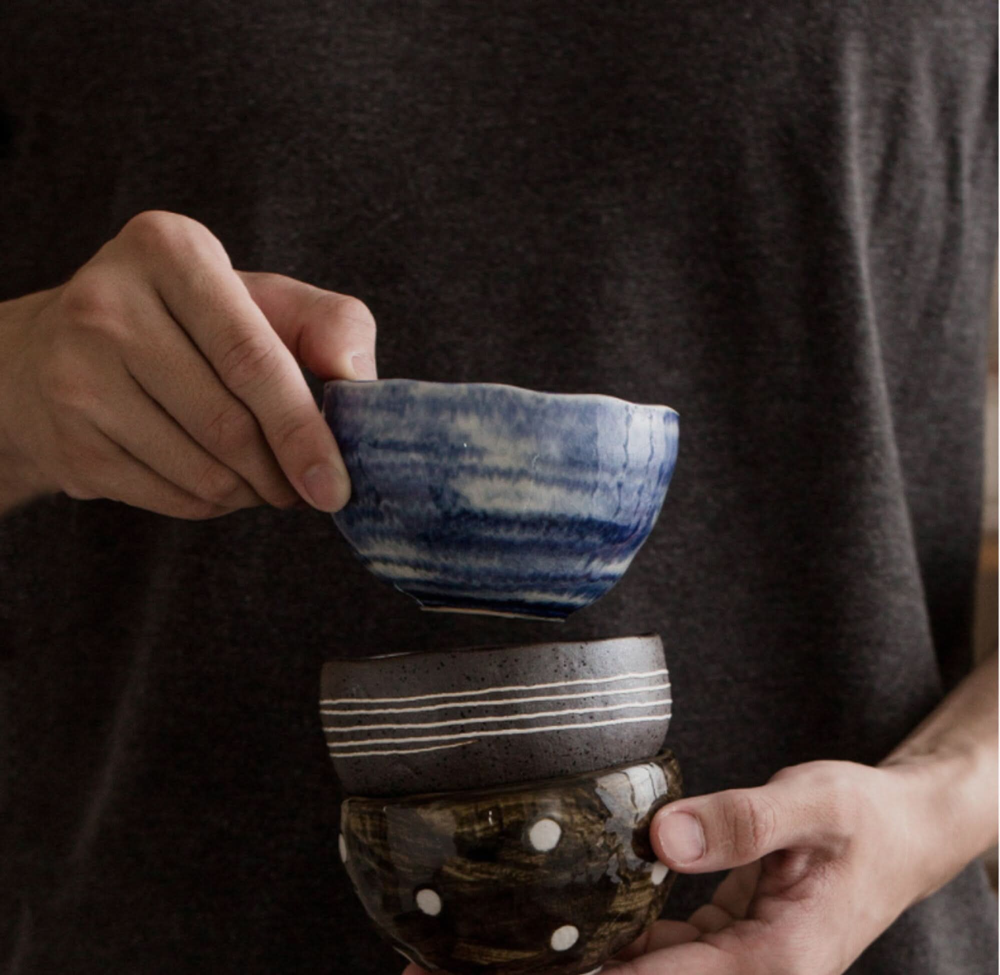 Japanese tea set with blue, white, and brown ceramic bowls.