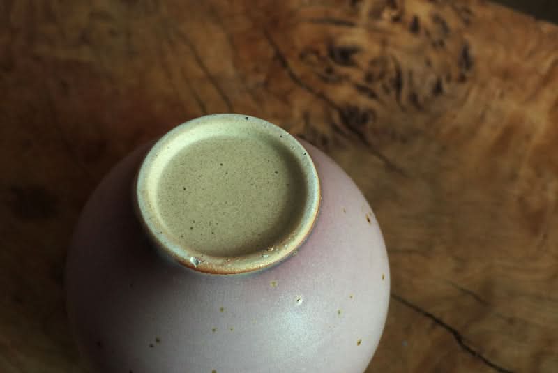 Handmade Coarse Pottery Large Round Vase, light purple speckled ceramic, natural wood backdrop.