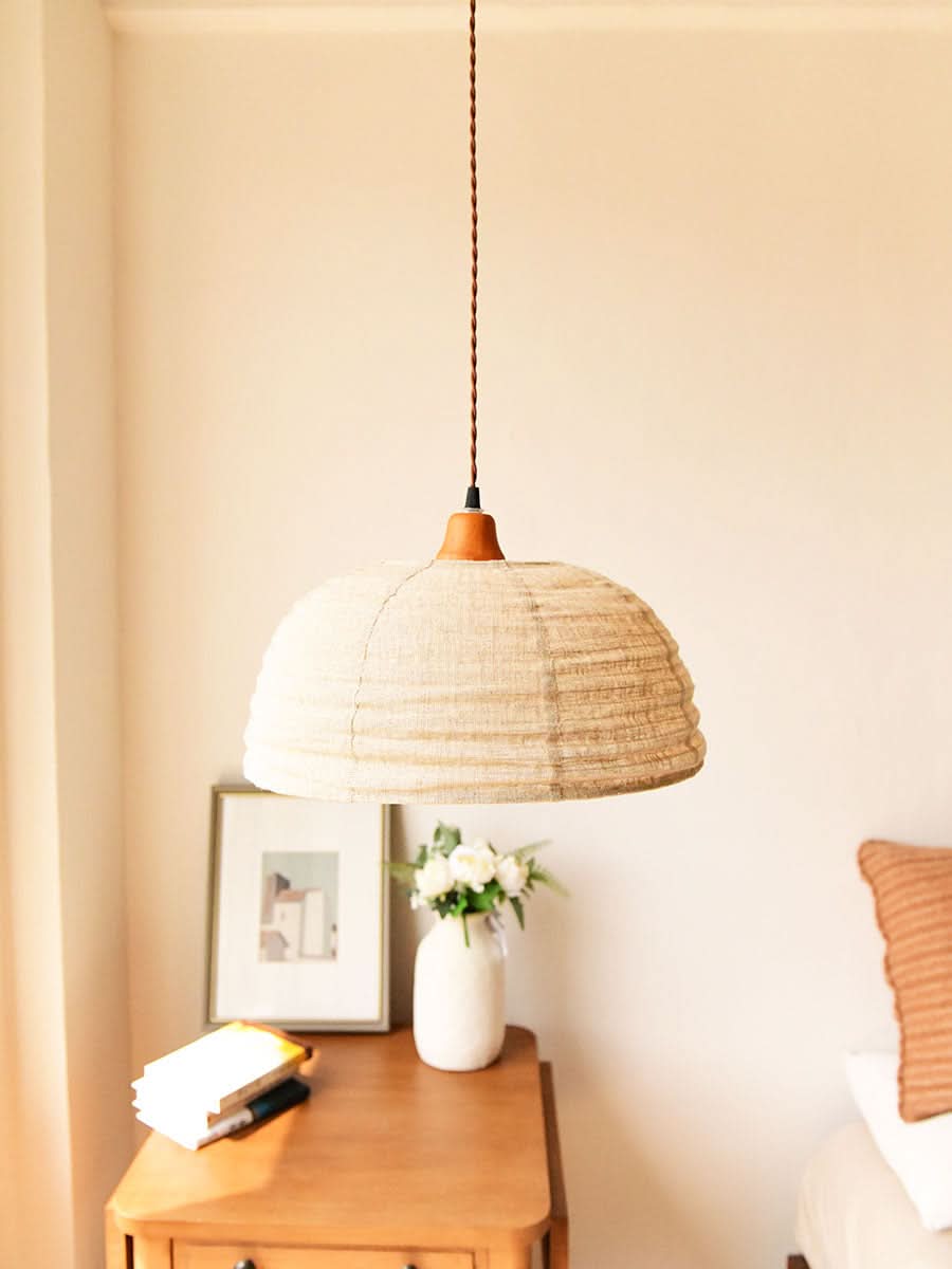 Dome lamp shade with natural hemp fabric, a cozy home decor accent.