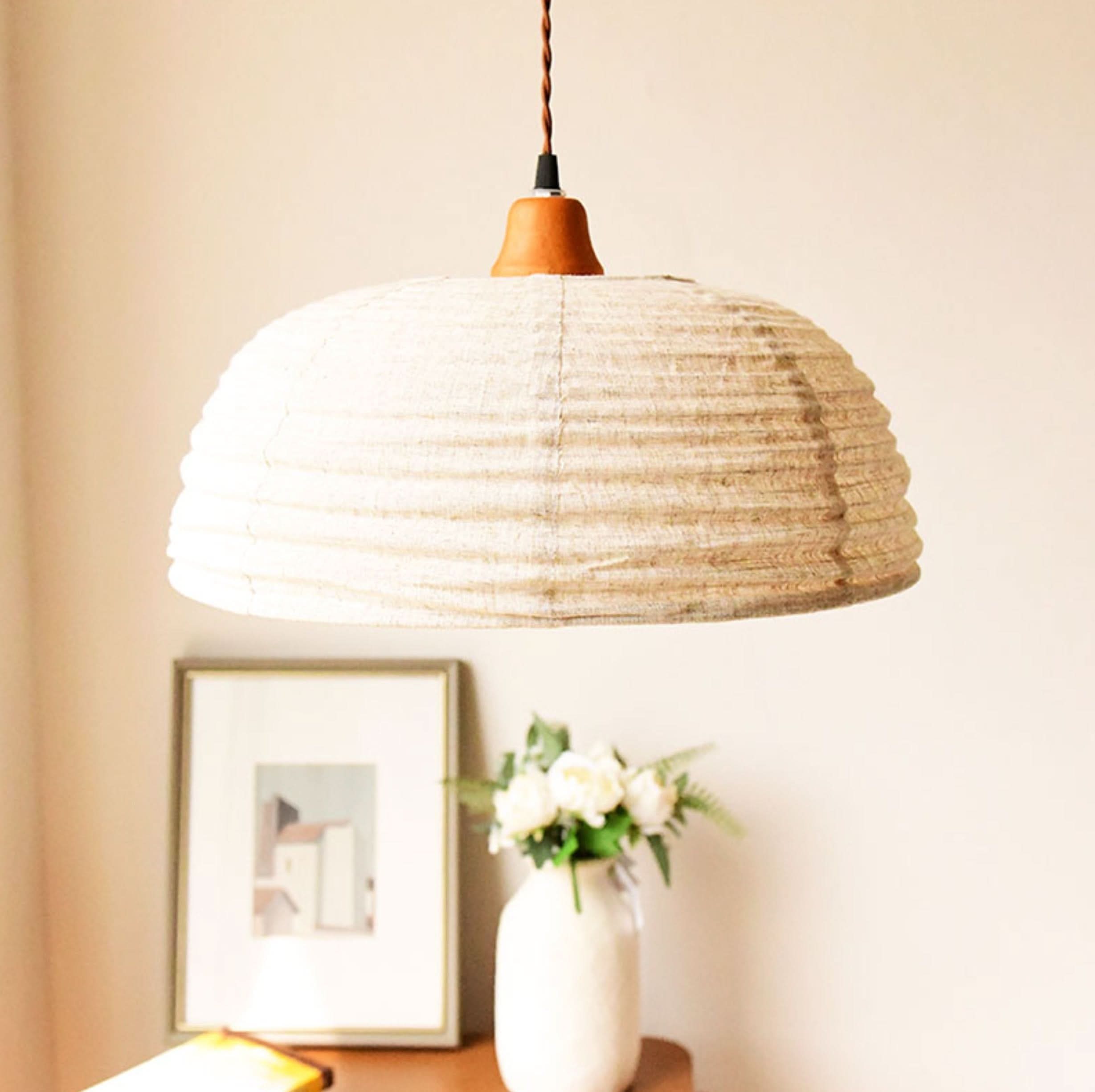Dome Lamp Shade with Hemp Fabric: Natural textured lamp shade with wooden accent, hanging from brown cord.
