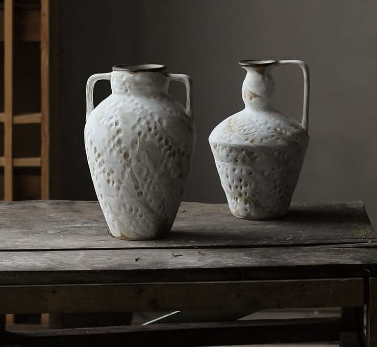 Wabi-sabi small ceramic vase with textured finish, displayed on a rustic wooden surface.