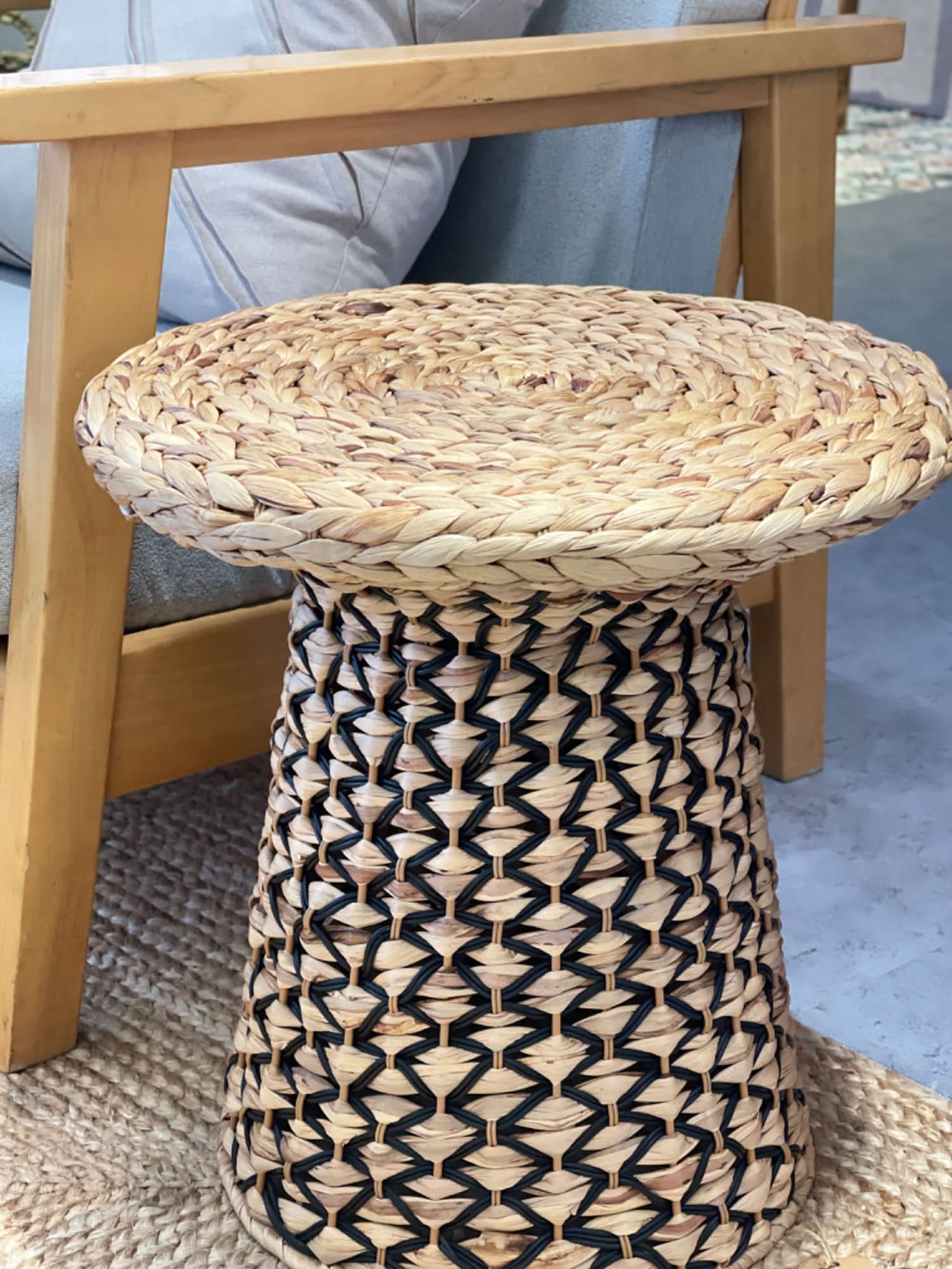 Wabi Sabi Coffee Table Straw: Woven natural straw and dark accent table with woven base and round top.