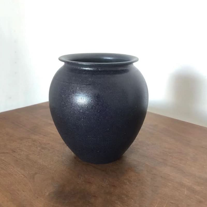 Dark speckled ceramic vase for flowers, home decor.