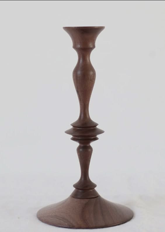 Walnut wood pillar candle holder with a minimalist design on a white background.