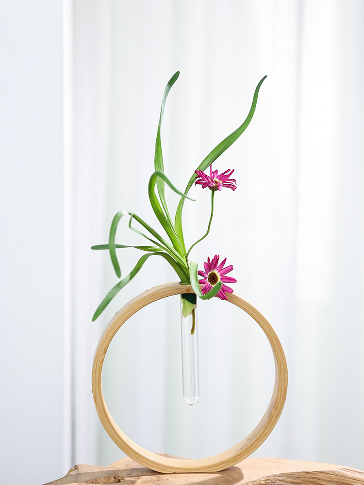 Round bamboo Wall Flower Vase with pink flowers and green leaves, home decor accent.