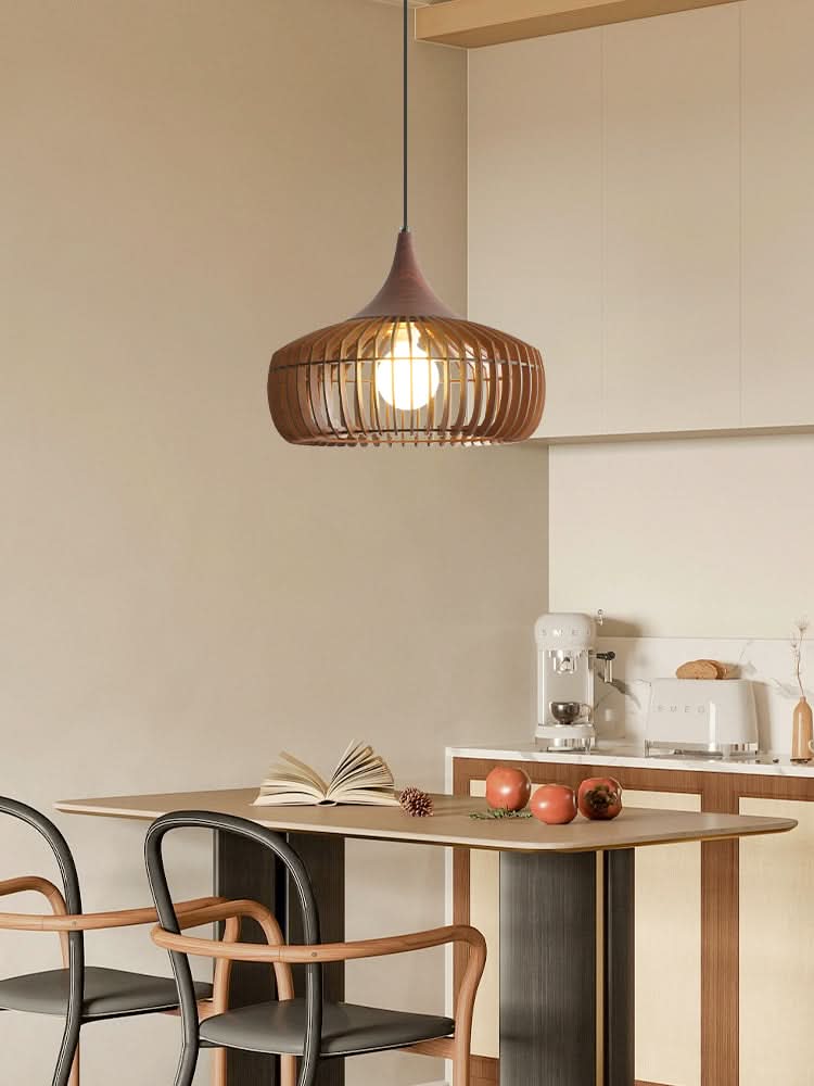 Brown wood light fixture with slats, over a dining table in a modern kitchen setting.