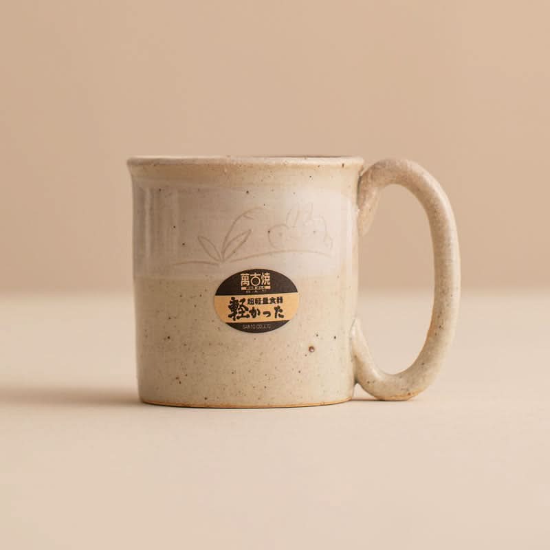 Stoneware Wangu Burning Rabbit Mug Made In Japan, beige speckled ceramic with embossed rabbit and Japanese label.
