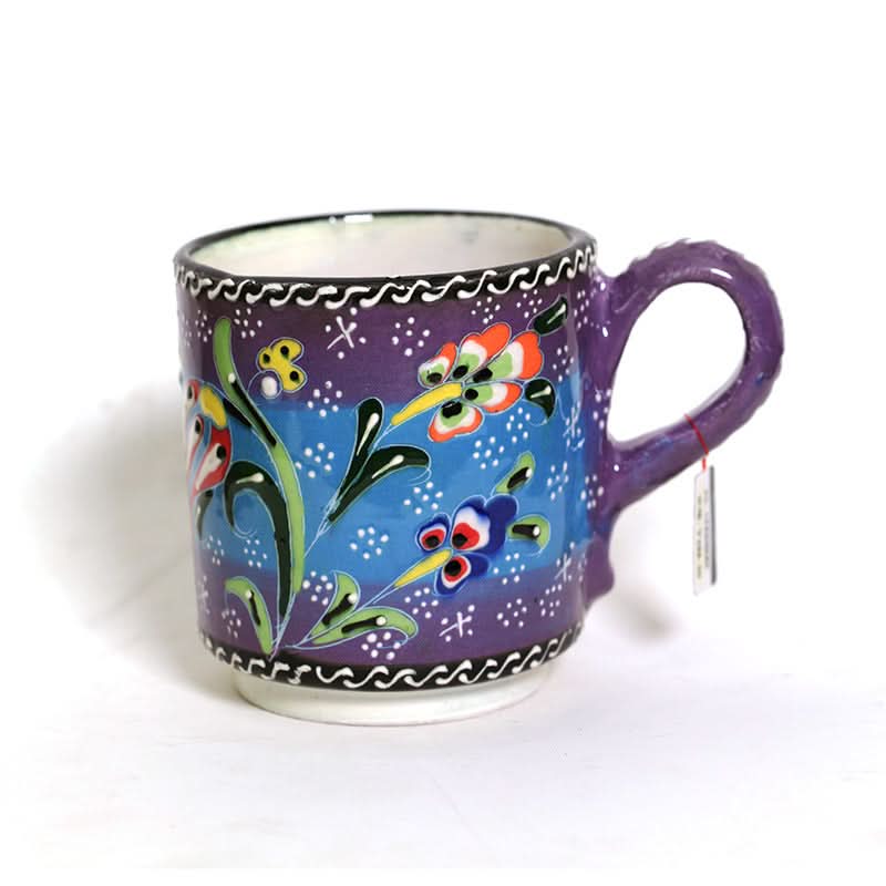 Purple Turkish glazed ceramic mug with vibrant floral design on blue background, white border.