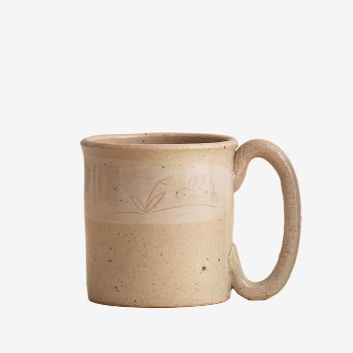 Stoneware Wangu Burning Rabbit Mug Made In Japan, beige speckled mug with etched bunny detail.