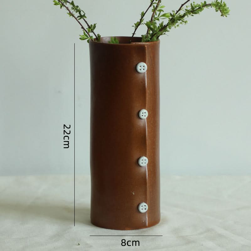 Brown textile folded ceramic cup with button detail, coffee mug.