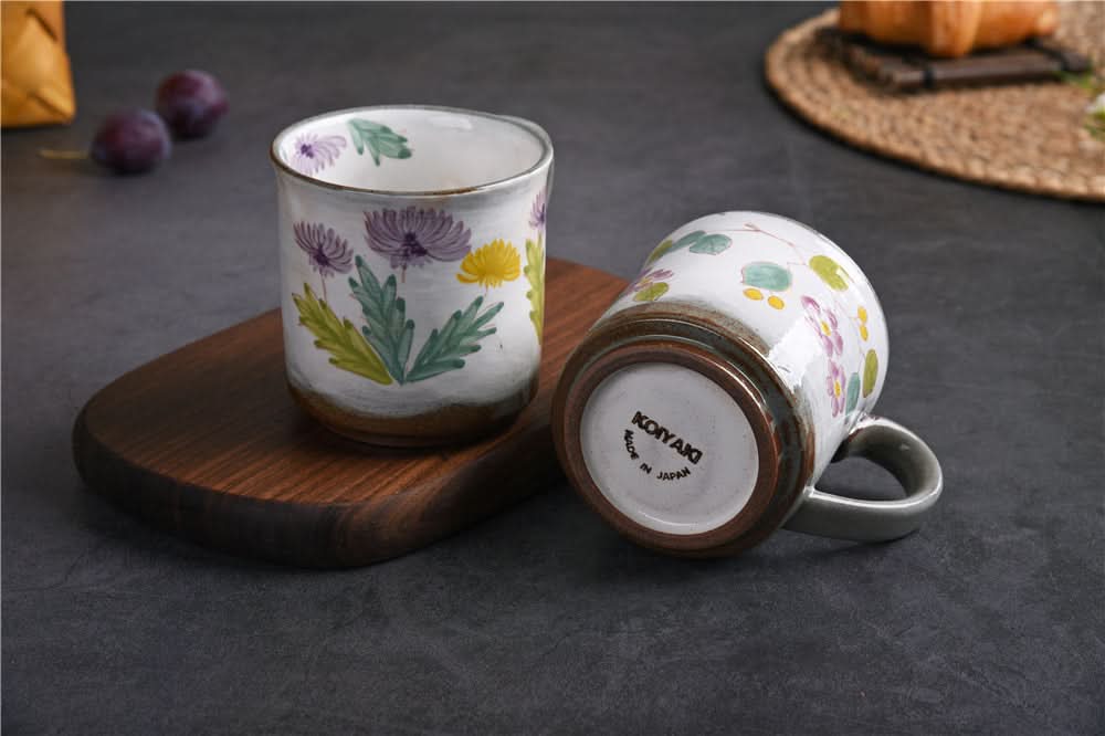 Japanese Underglaze Ceramic Flower Mugs hand-painted with purple and yellow blooms on white ceramic.