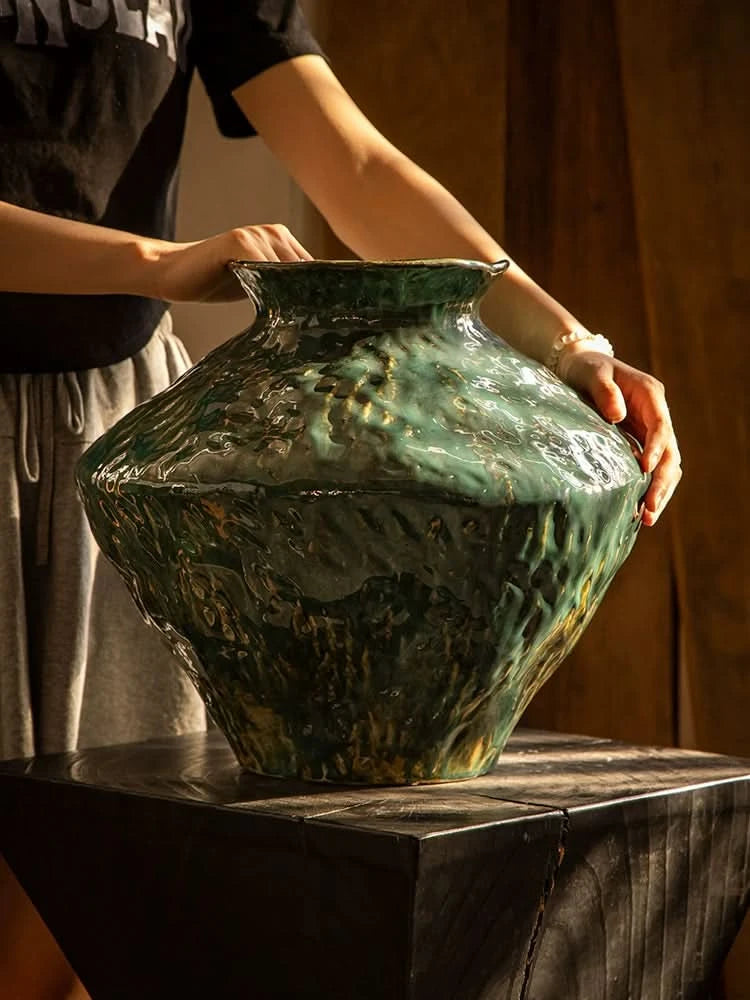 Wabi-Sabi Distressed Rustic Vase with dark green glaze, ceramic material, on dark wood table.