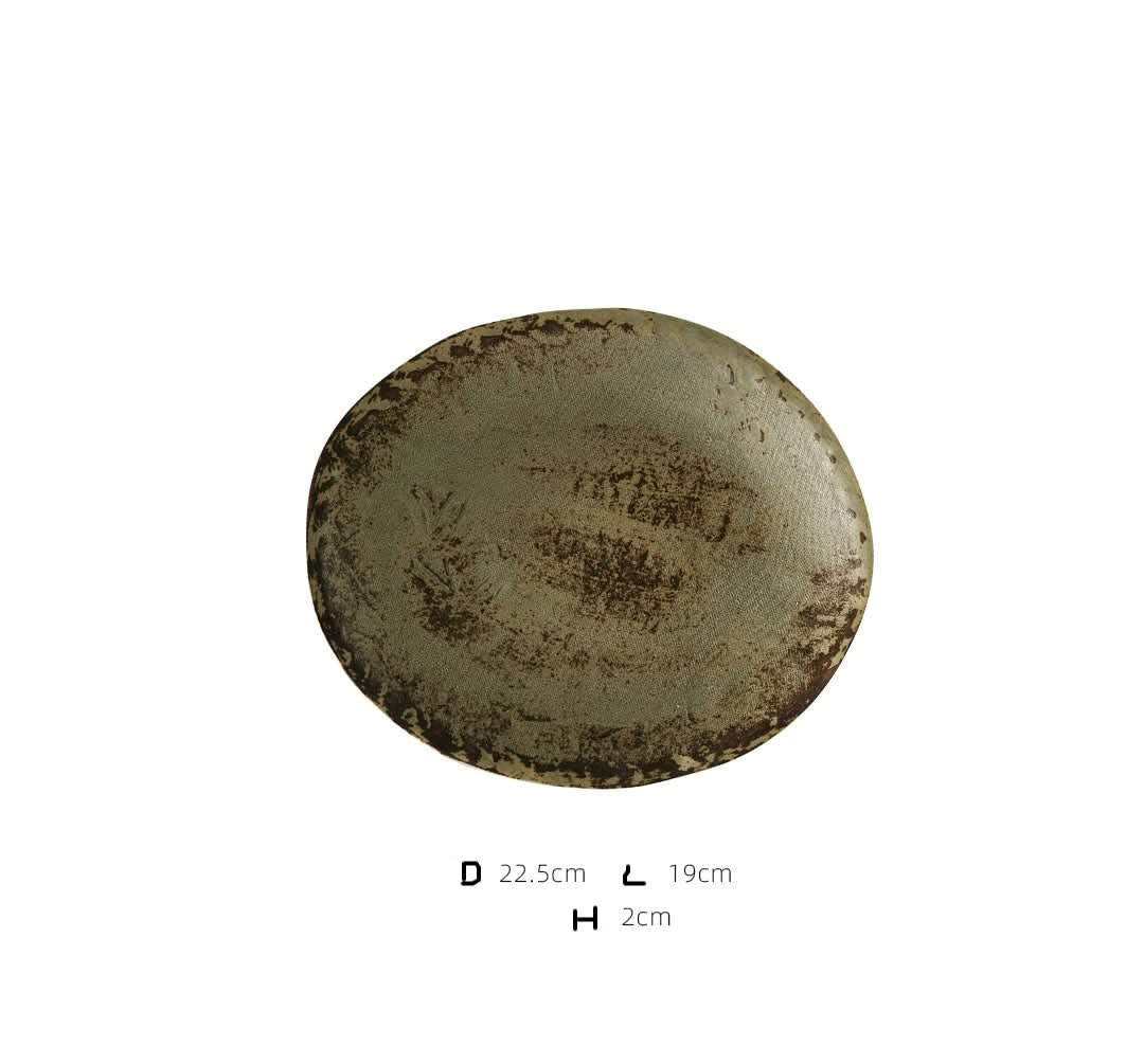 Unglazed ceramic plate with subtle cloth texture and rustic finish. Home decor accent.