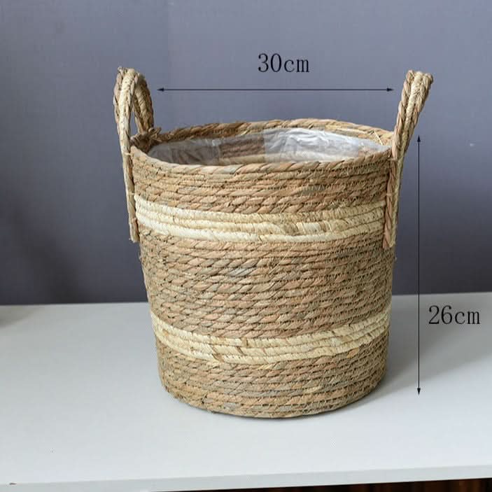 Natural woven plant basket with handles, beige and tan stripes, 30cm diameter.