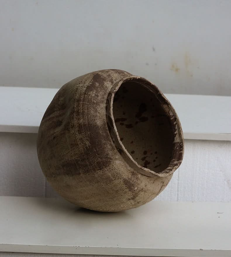 Handmade ceramic vase, earthy brown, textured home decor accent.