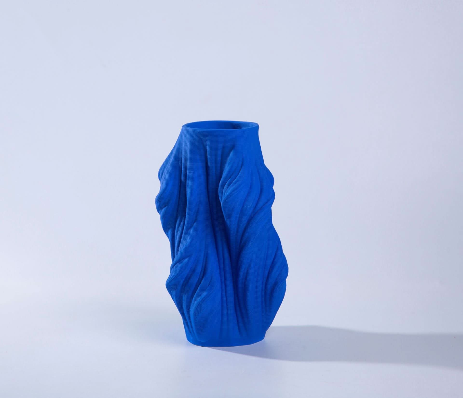 Blue 3D printed ceramic vase with draped fabric design, home decor accent.