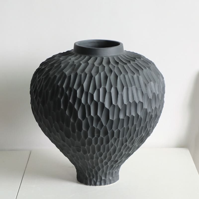 Wabi-Sabi Carved Irregular Black Ceramic Vase with textured honeycomb pattern on white background.