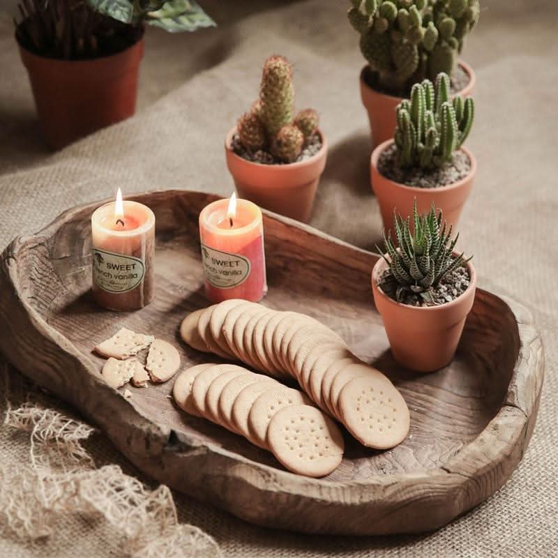 Rustic wooden distressed serving bowl with candles and cookies, home decor accent.