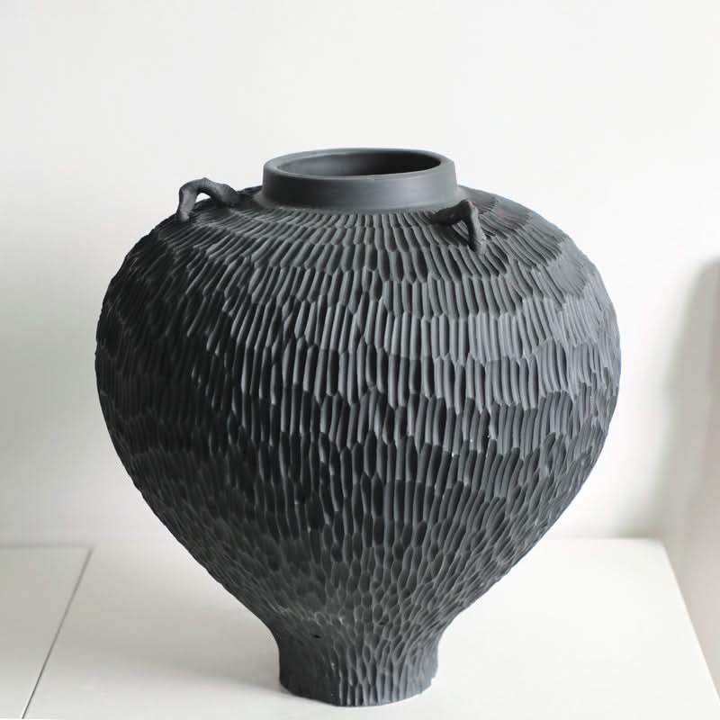 Wabi-sabi Carved Irregular Black Ceramic Vase with loop handles on a white surface.