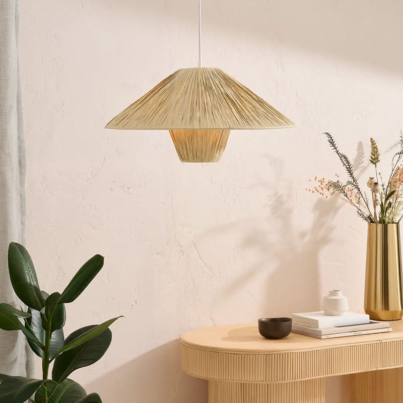 Natural raffia lampshade geometric pendant light hanging over a wooden console table.