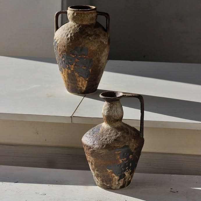 Two textured, earth-toned ceramic vases with handles, home decor.