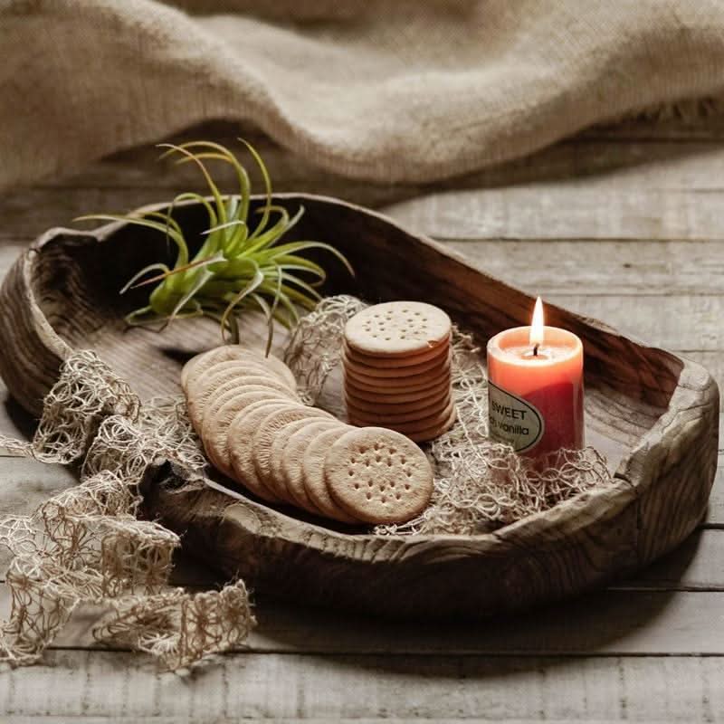 Wooden distressed serving bowl with crackers, vanilla candle, air plant, and burlap.