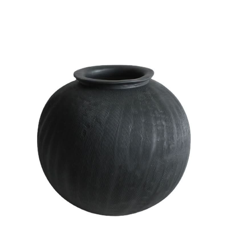 Black ceramic vase with subtle vertical texture, perfect for home decor.