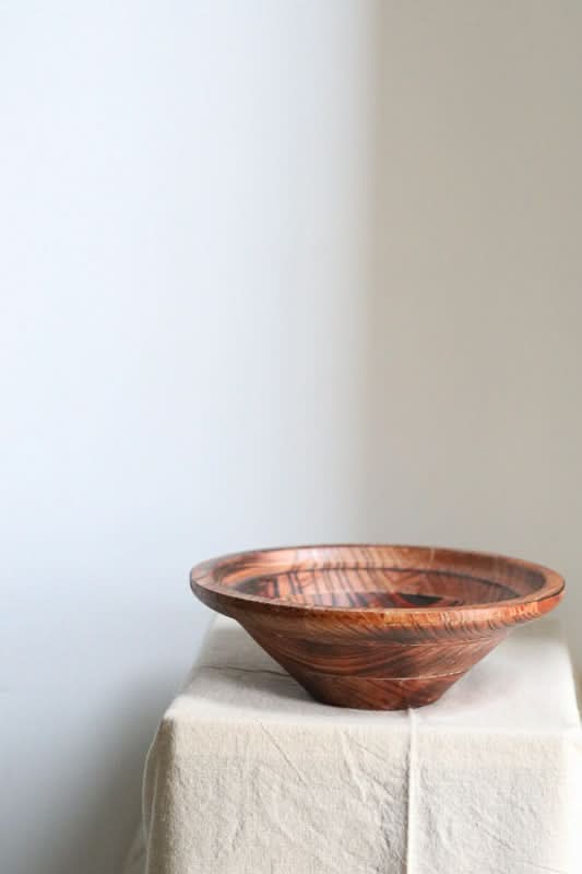 Handmade Retro Bowl: rich wood grain, warm brown tones, displayed on neutral linen cloth.