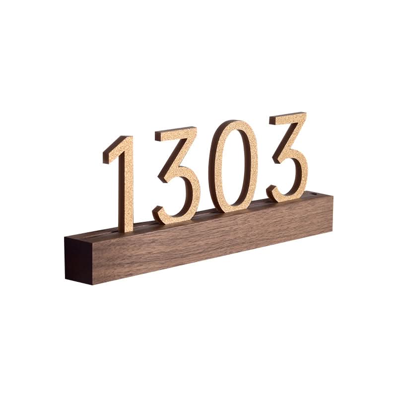Solid wood custom door plate with gold numbers "1303" on a walnut base.