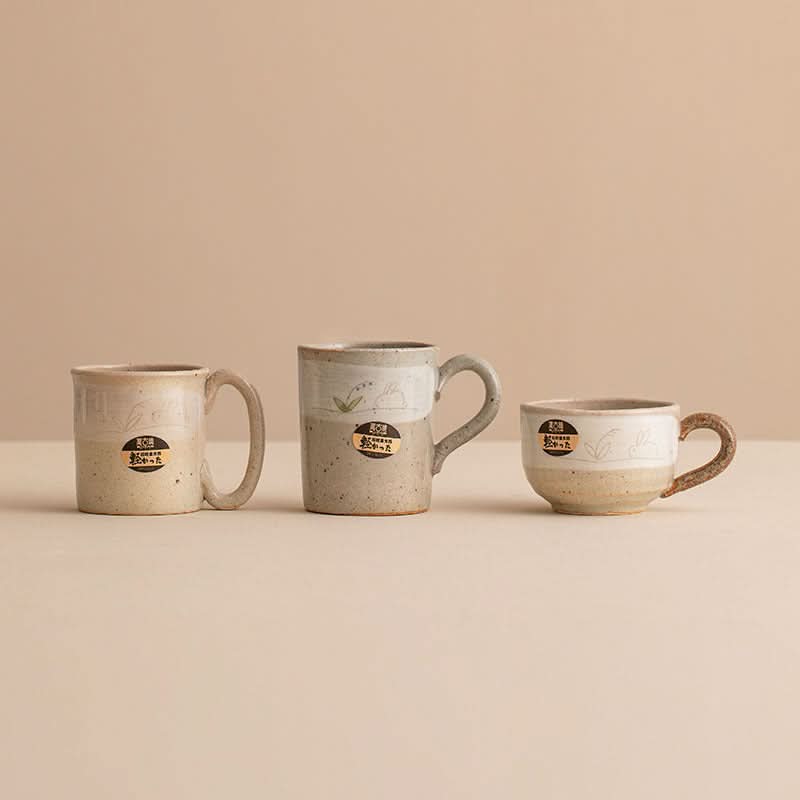 Stoneware Wangu Burning Rabbit Mug, beige & grey ceramic, handmade in Japan.