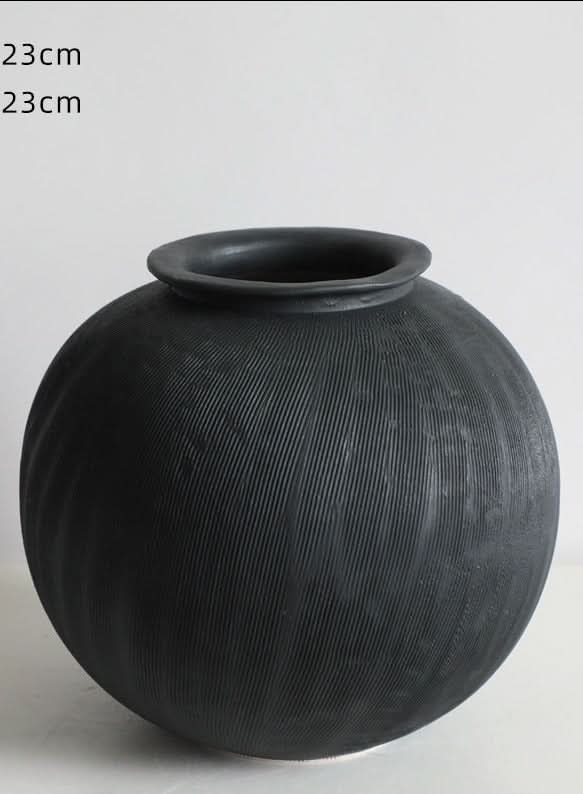 Black ceramic vase with a textured ribbed finish, 23cm x 23cm, home decor.