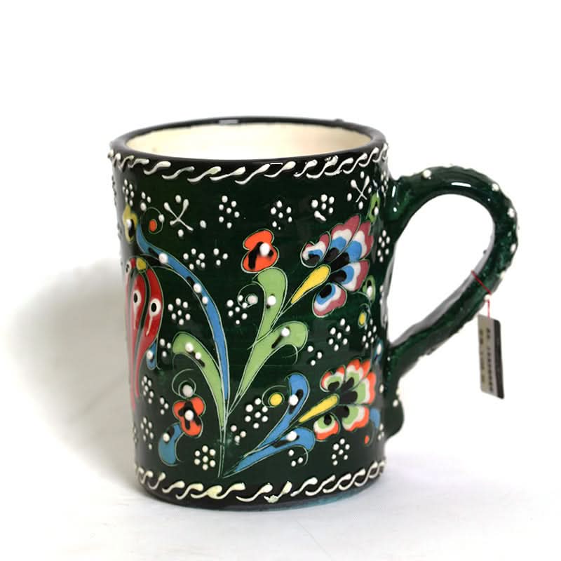 Dark green Turkish glazed ceramic mug with floral patterns and white accents.