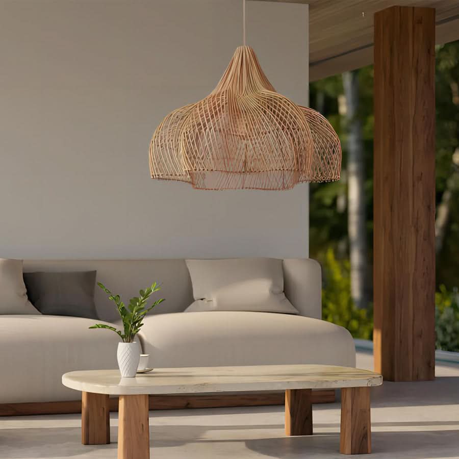 Natural rattan pendant light with a teardrop shape hangs over a modern living room vignette.