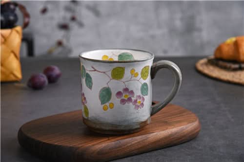 Japanese Underglaze Ceramic Flower Mug, hand-painted with purple flowers & green leaves on white ceramic.