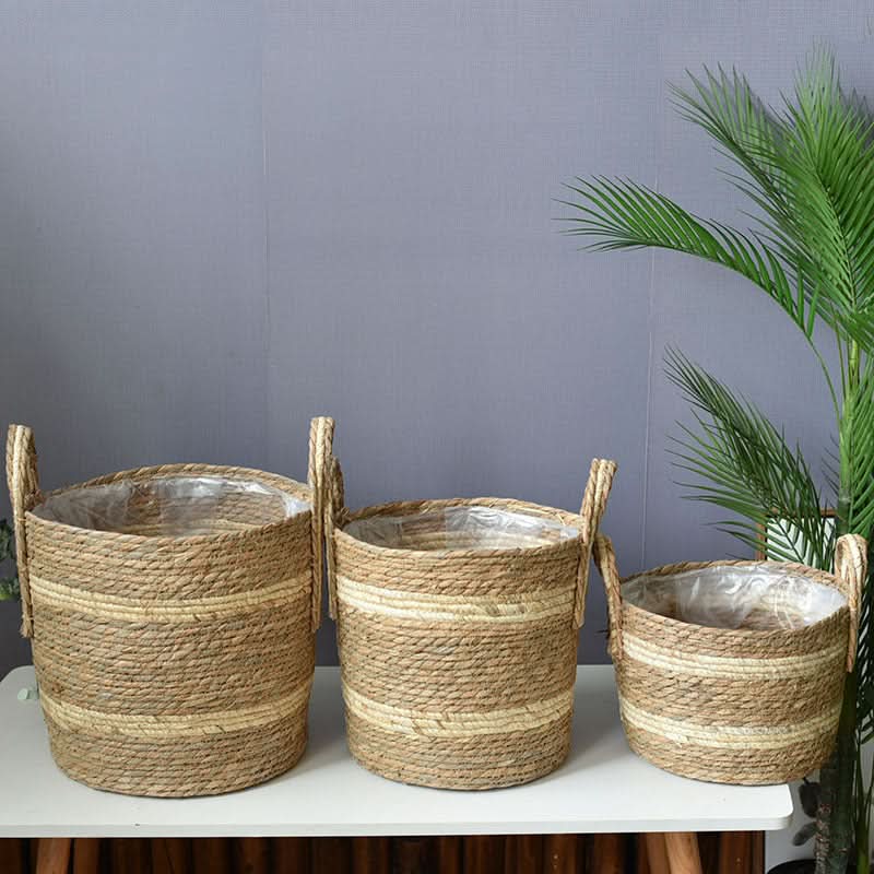 Natural woven plant basket set with handles and plastic liner, home decor accent.
