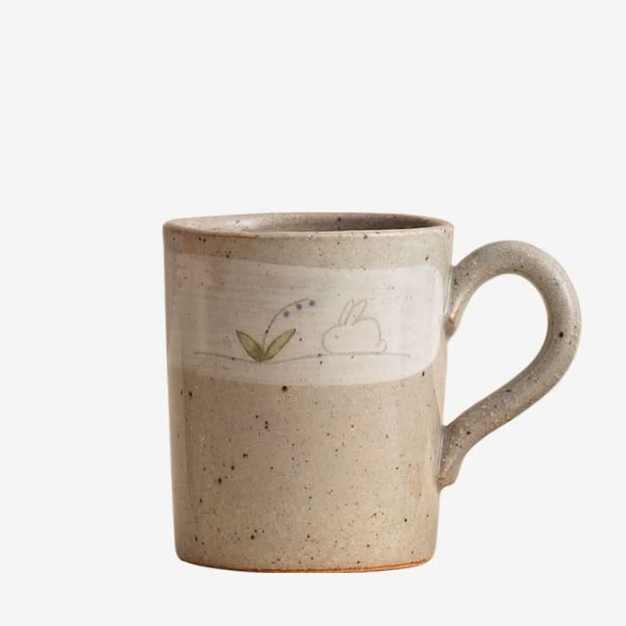 Stoneware Wangu Burning Rabbit Mug Made In Japan, beige, speckled ceramic with bunny and flower design.