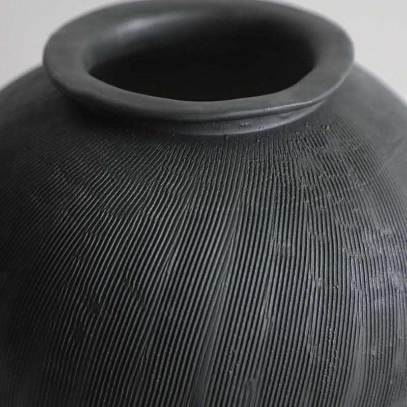 Black ceramic vase with textured finish, home decor accent.