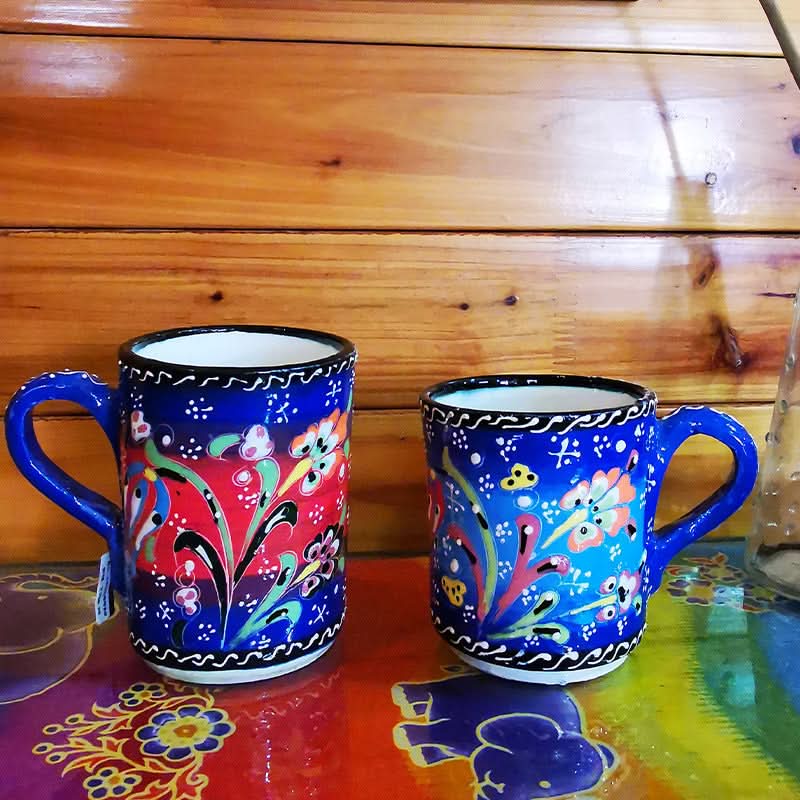 Two blue Turkish glazed ceramic mugs with floral patterns, home decor