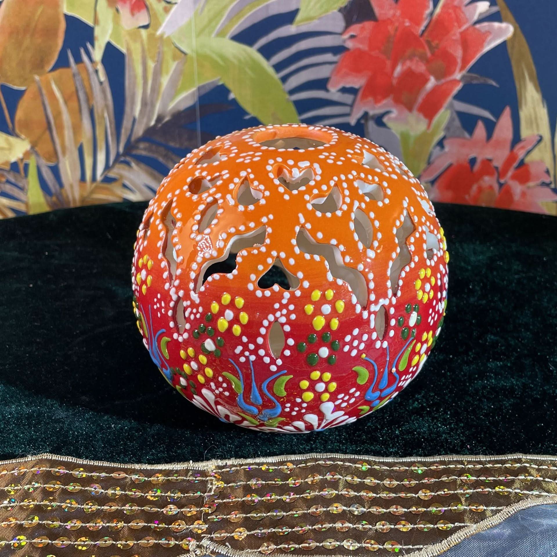 Orange Turkish Ceramic Hand-painted Candle with floral cutouts on dark green velvet and sequin trim.