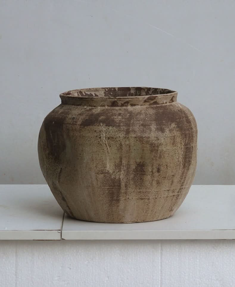 Rustic, earth-toned handmade ceramic vase, perfect for home decor.
