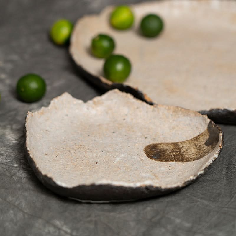 Wabi-sabi irregular beige serving tray with textured surface and dark rim, home decor.