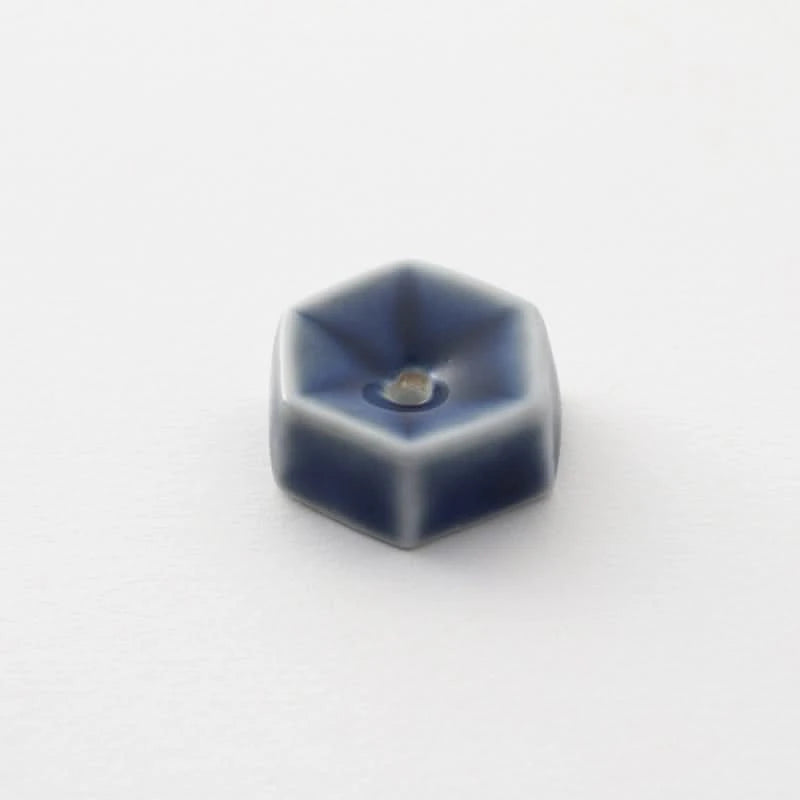 Blue ceramic incense holder made in Japan, hexagonal shape with a light grey glaze.