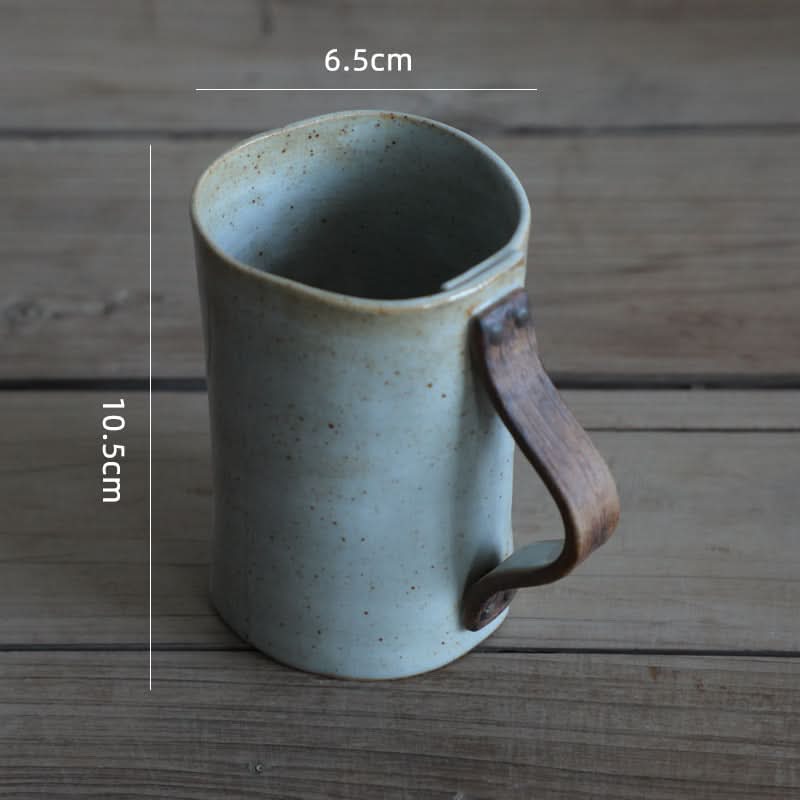 Grey textile folded ceramic mug with wooden handle, part of a coffee mug set.