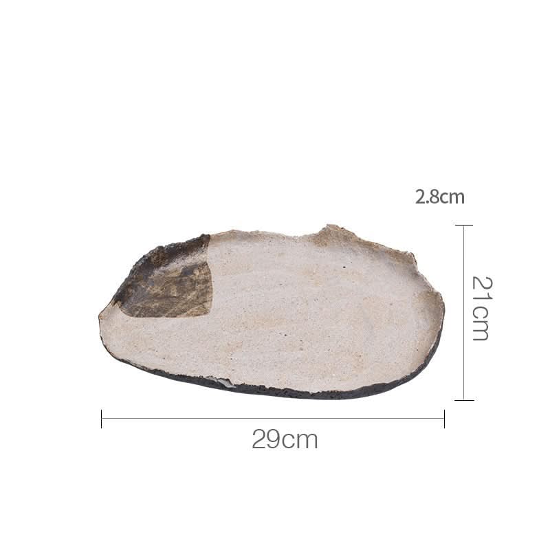 Wabi-sabi irregular beige serving tray with textured dark rim.