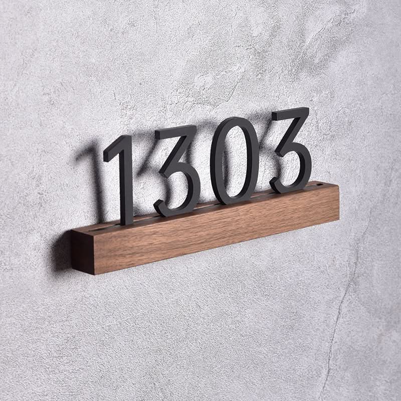 Solid wood custom door plate with walnut beech base and black numbers.